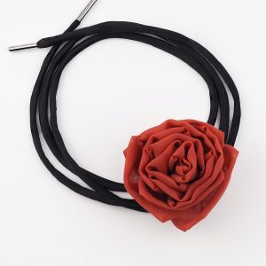 Red silk rose choker necklace with black satin lace by ByRova, designed and handmade by Ksenia Semirova, shown in flat lay with coiled lace