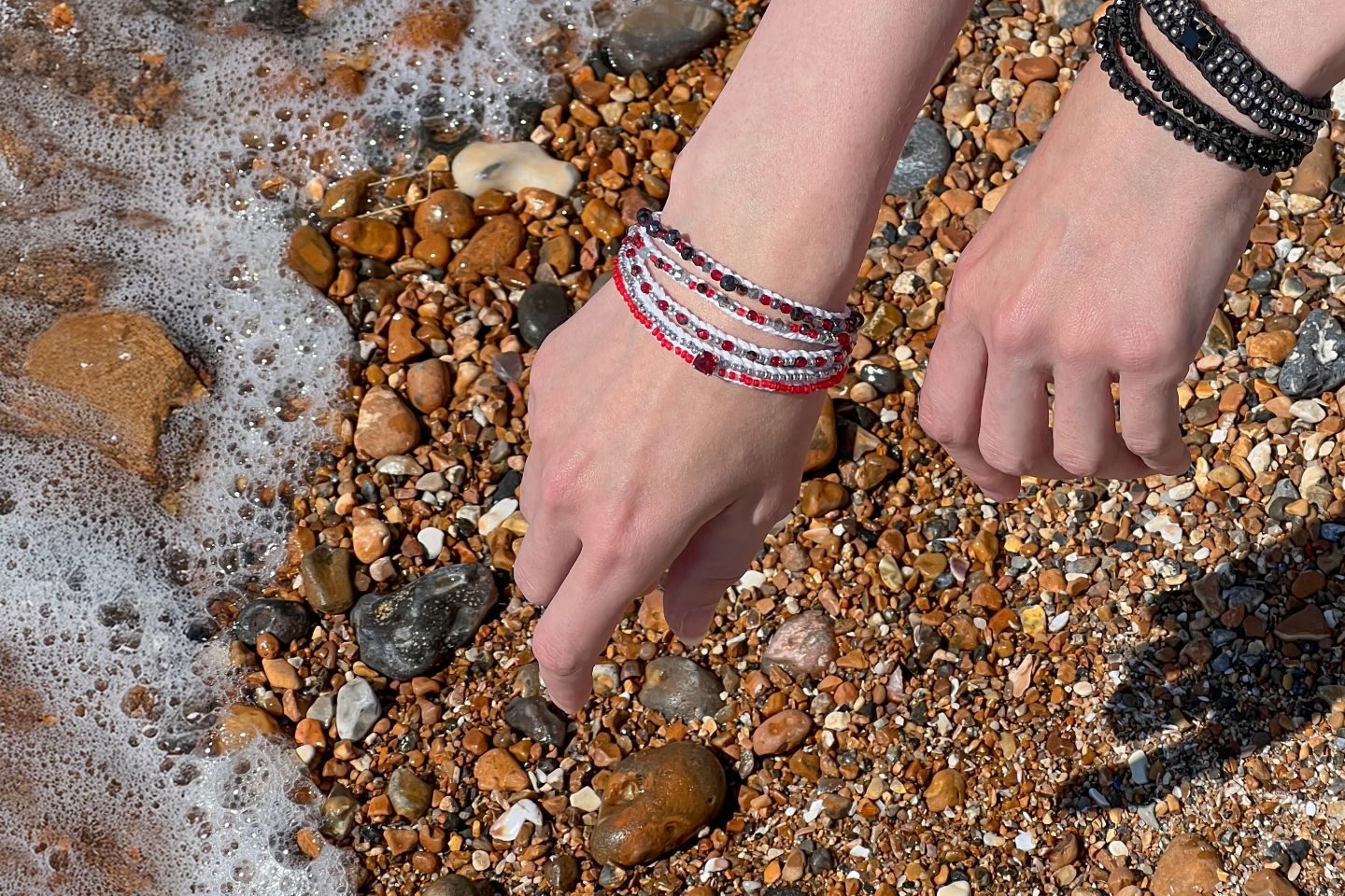 Handmade boho jewellery from the Roots & Rhythm collection, featuring layered bracelets styled by the seaside, heritage-inspired design