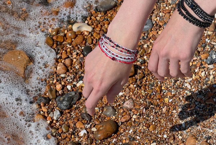 Handmade boho jewellery from the Roots & Rhythm collection, featuring layered bracelets styled by the seaside, heritage-inspired design