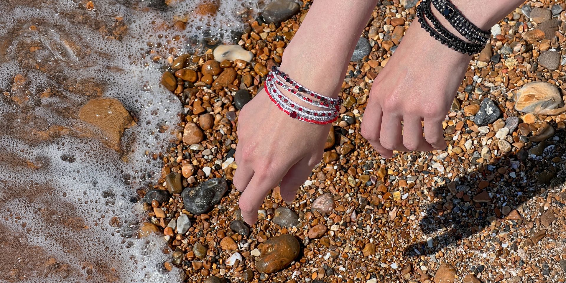 Handmade boho jewellery from the Roots & Rhythm collection, featuring layered bracelets styled by the seaside, heritage-inspired design