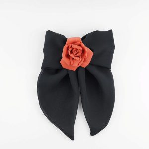 A handmade hair clip featuring a large black chiffon bow measuring approximately 16x25 cm, adorned at the center with a single red silk rose about 6 cm in diameter. The accessory combines bold black and vibrant red colors, showcasing elegant craftsmanship suitable for gothic fashion or evening wear