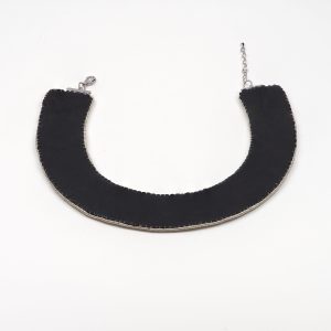 Back view of a handmade black collar necklace with smooth leather backing, hand-stitched edges, and adjustable lobster clasp fastening.