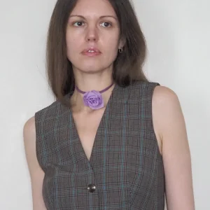 Model wearing handmade purple silk organza rose choker with suede lace, styled with a checked sleeveless dress
