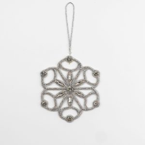 Full view of the Jewels of Winter Six-Pointed Cut-Out Snowflake Ornament by Ksenia Semirova. Handmade with the pearl-setting technique in a lace-like silver design featuring fire-polished glass beads, crystals, and a silver hanging cord.