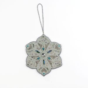 Close-up of the Jewels of Winter Six-Pointed Snowflake Ornament by Ksenia Semirova. Detailed bead and crystal work in white, silver, and turquoise tones, created with the pearl-setting technique and finished with a white leather back.