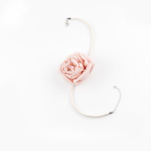 Flat lay of the Pink Silk Rose Choker Necklace showing a blush-pink silk rose centerpiece, dupioni silk band, and silver lobster clasp with star charm chain