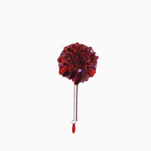 Close-up of the handcrafted red dahlia brooch with beaded details and pendant drop, photographed on a white background