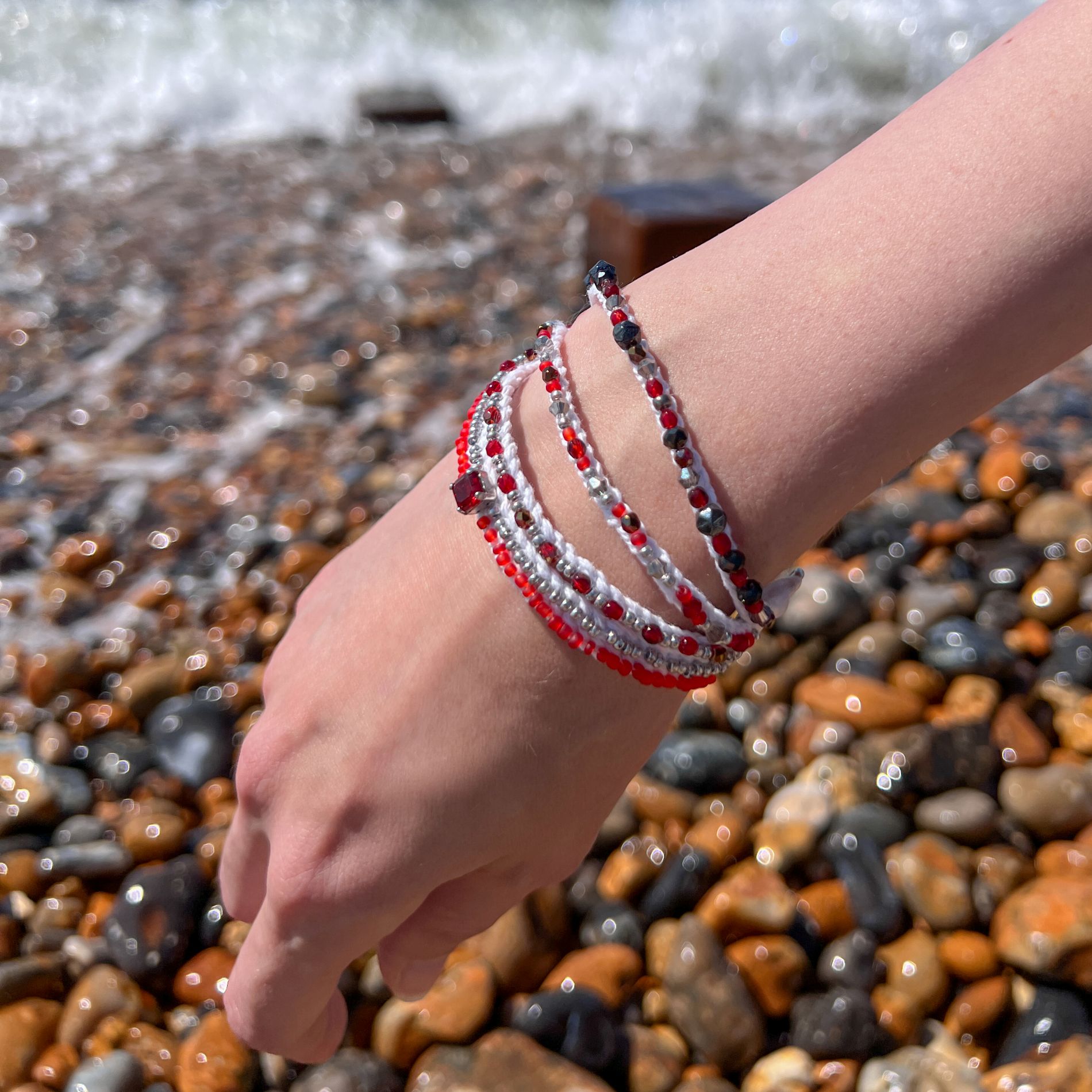 Red_White_Multi-Strand_Bracelet_Close-Up_at_Beach