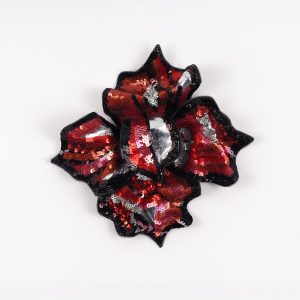 Front view of red and black hand-embroidered floral brooch by Ksenia Semirova, featuring sequins, beads, and silver details on silk organza