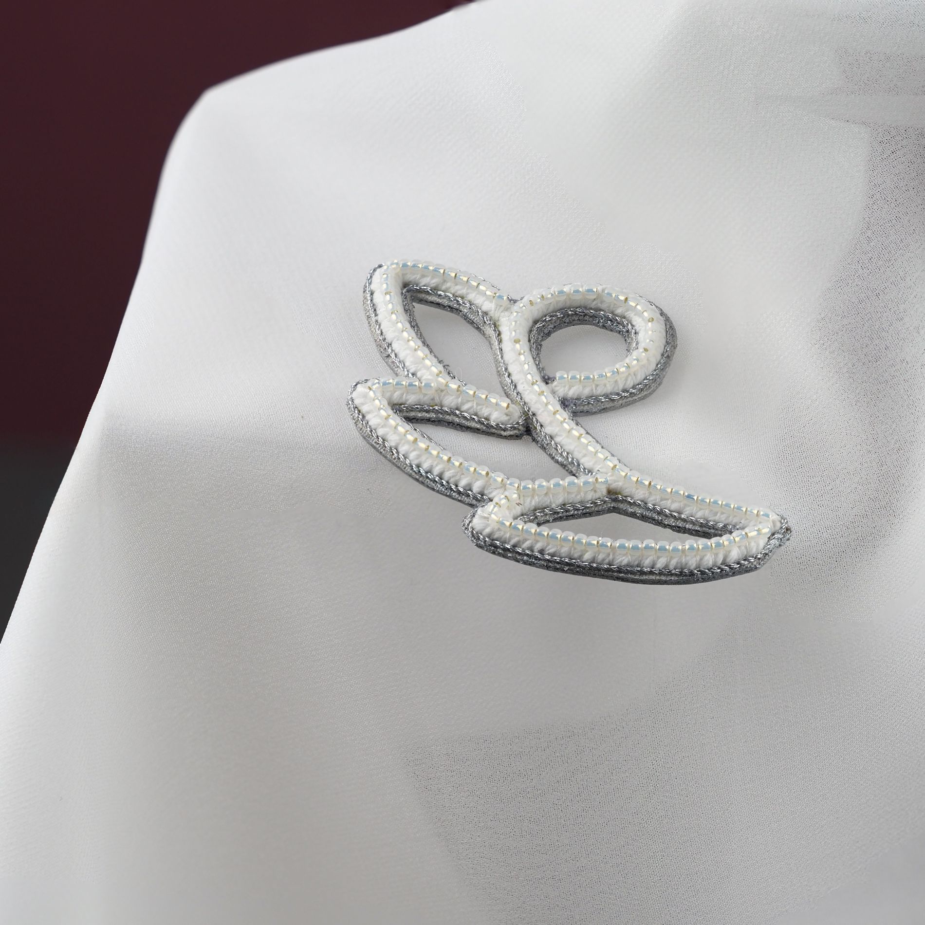 White_Silver_Floral_Bag_Charm_Detail_on_Fabric