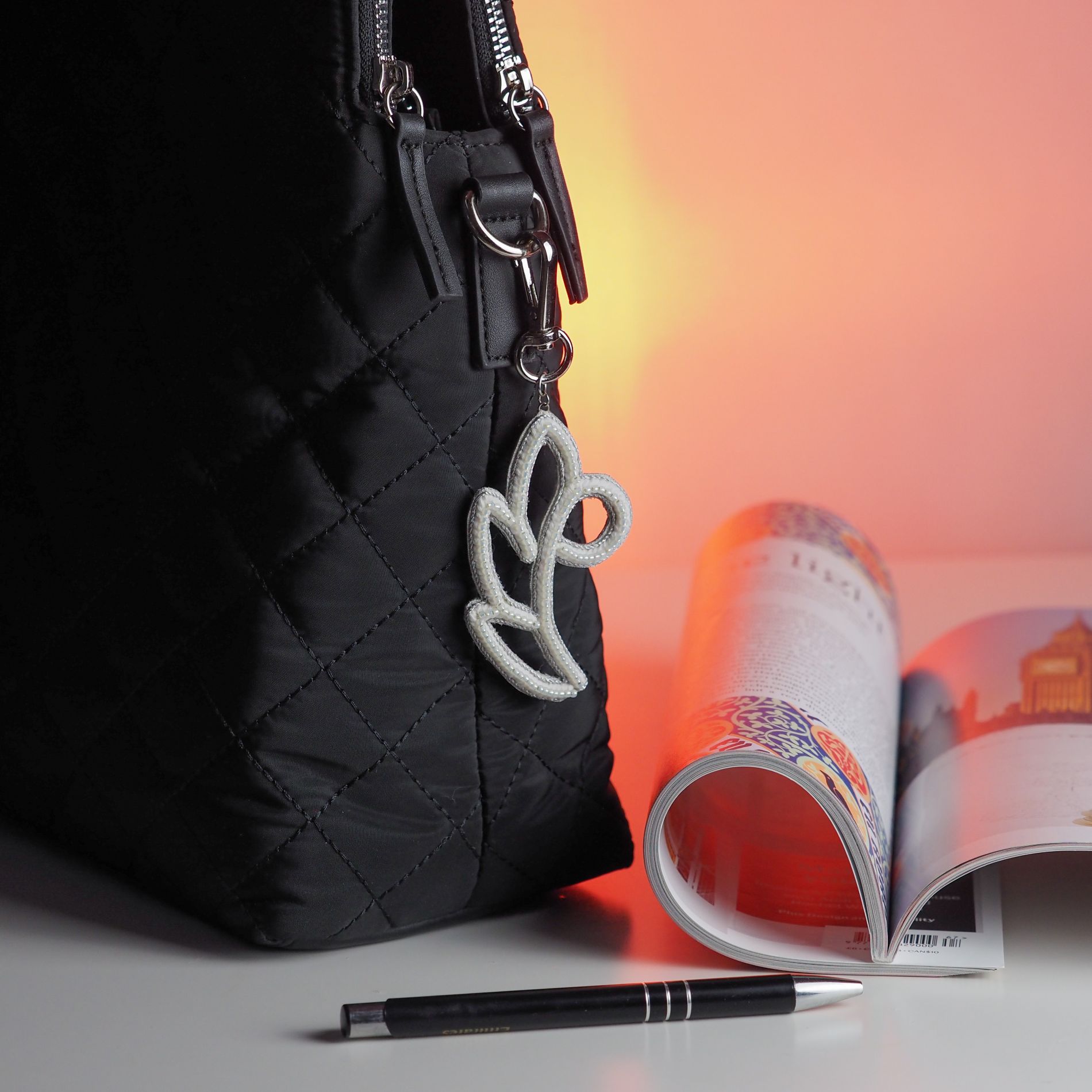 White_Silver_Floral_Bag_Charm_on_Black_Quilted_Bag