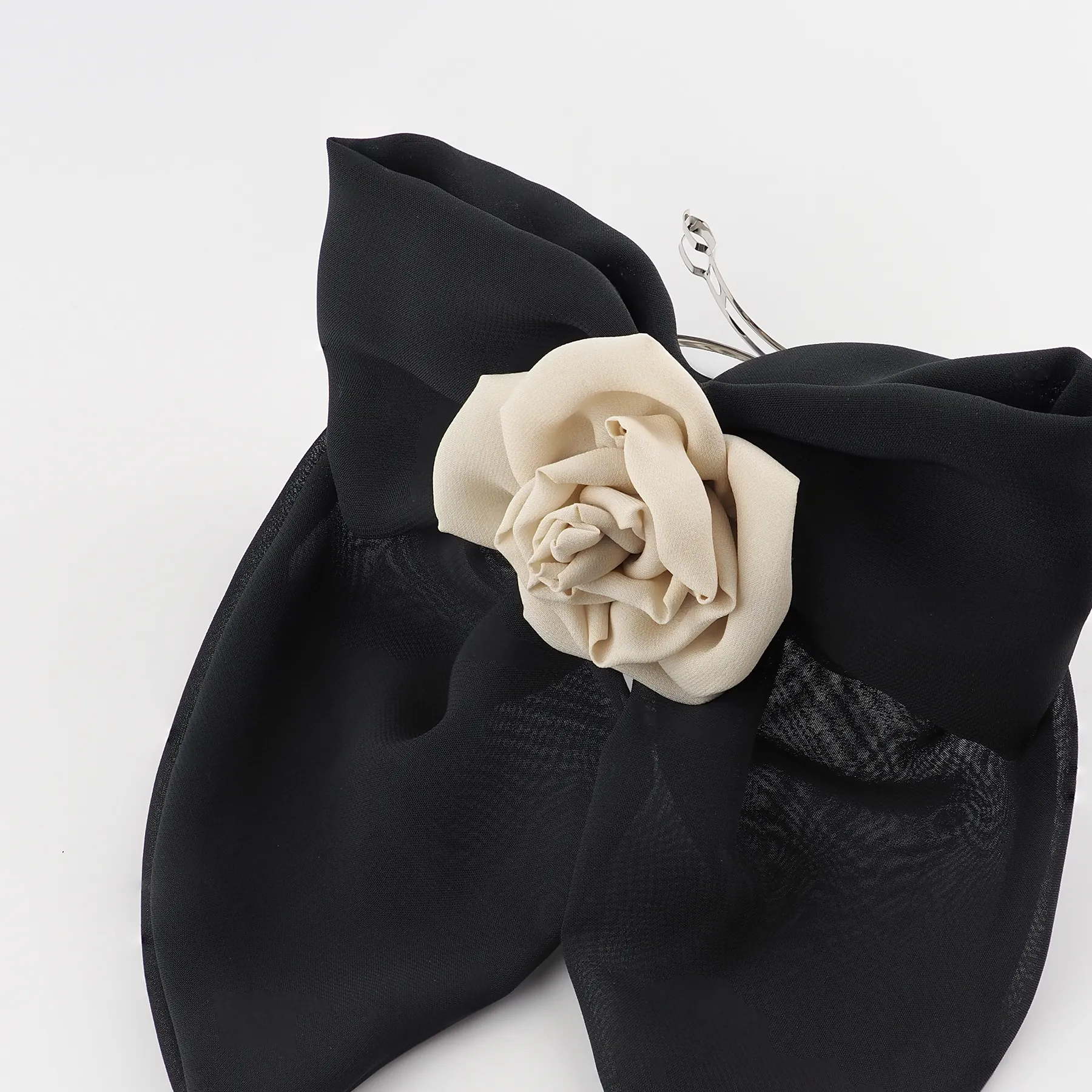 close-up-of-a-black-chiffon-bow-hair-clip-with-a-handmade-nude-chiffon-rose