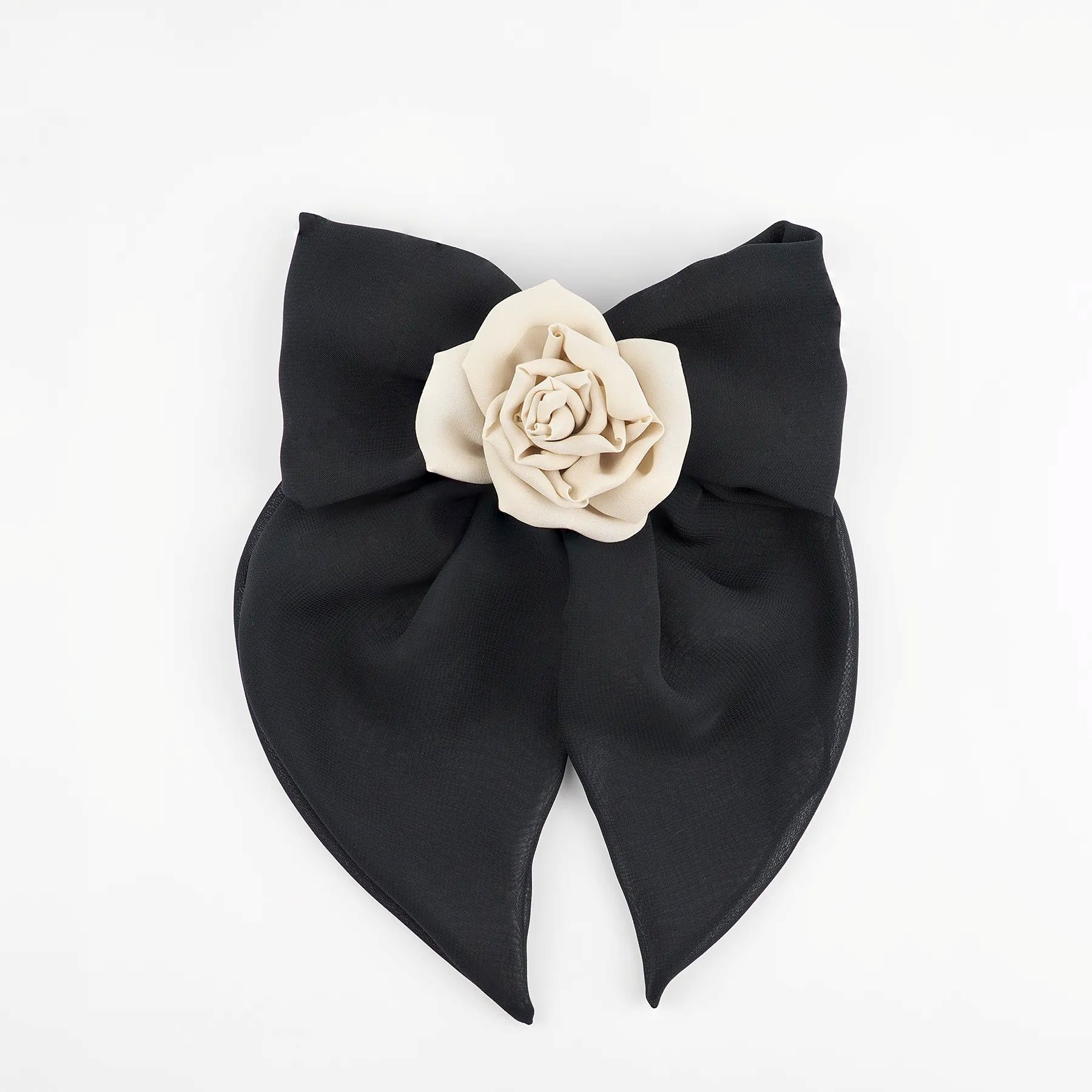 front-view-of-a-black-chiffon-bow-hair-clip-featuring-nude-chiffon-rose