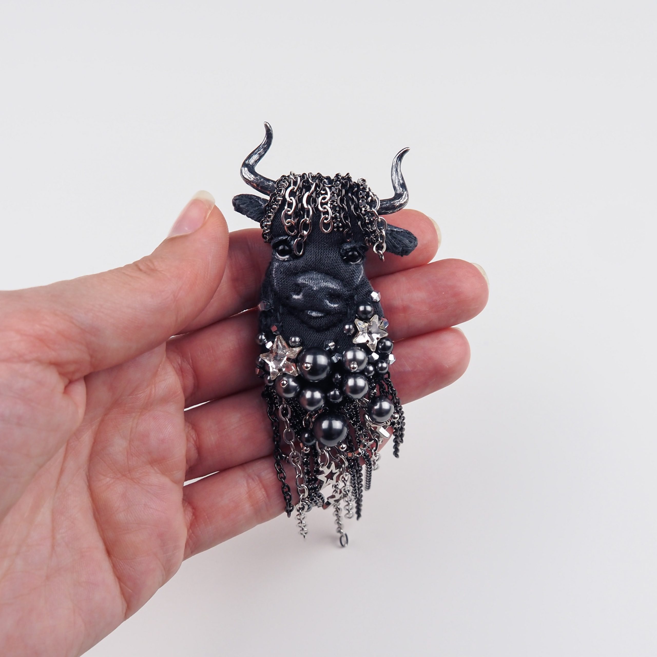 taurus-textile-brooch-in-hand-for-scale